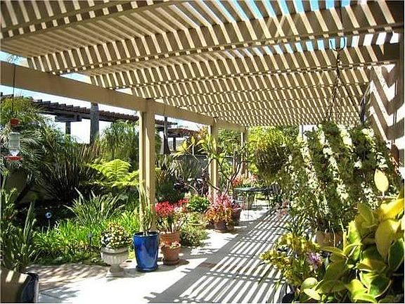 gorgeous covered back patio with gardens