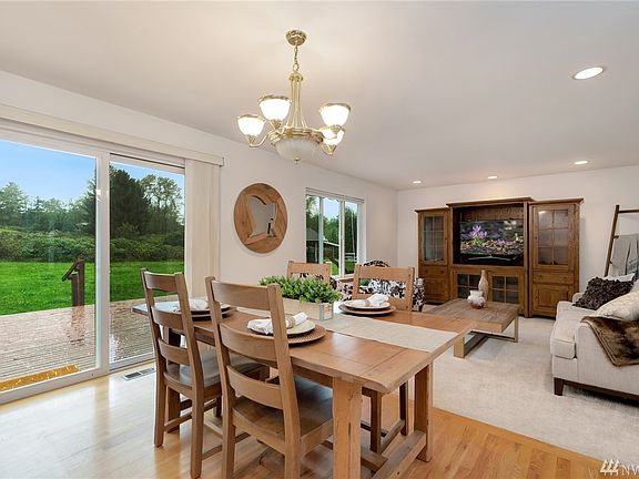 Hardwood floor entry flows into the kitchen and eating space.