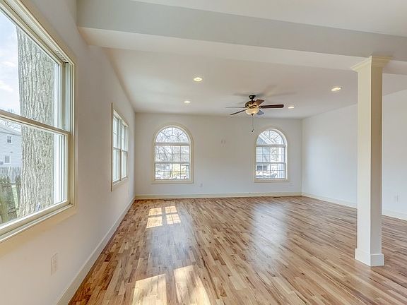 Gorgeous open floor living room with abundant natural light, next to kitchen.