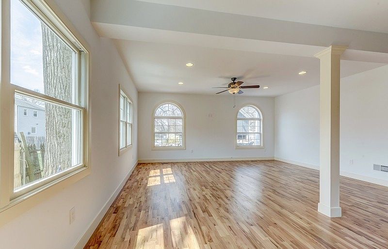 Gorgeous open floor living room with abundant natural light, next to kitchen.