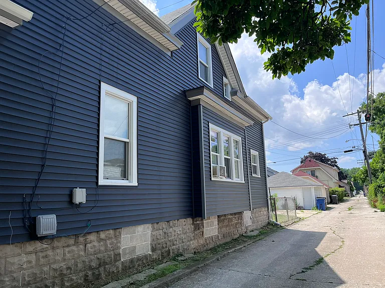 Ally view of the property, showing the off street parking shared by other tenant.
