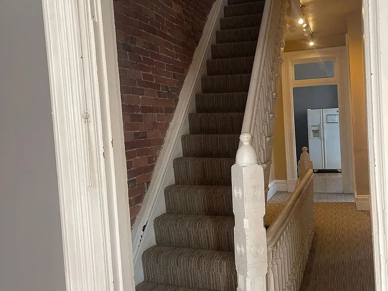photo taken from Living room looking at hallway to the kitchen and steps to go to top floor
