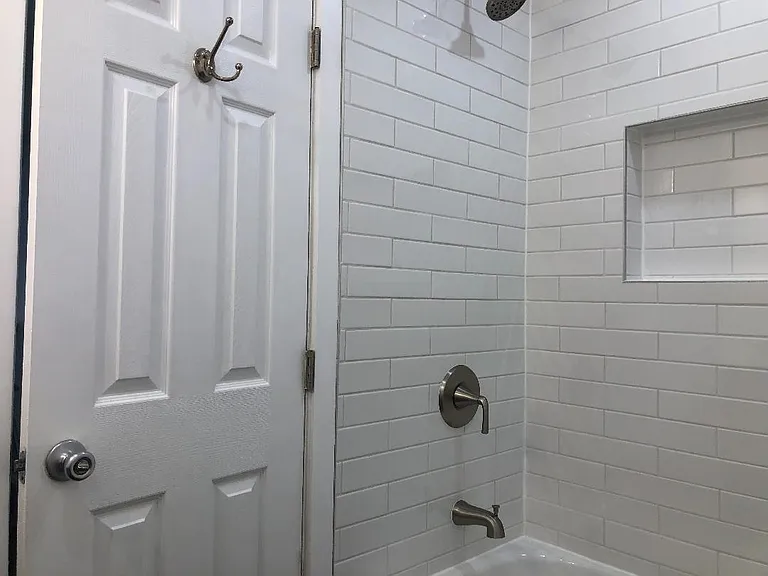 Another picture of bathroom and shower with door