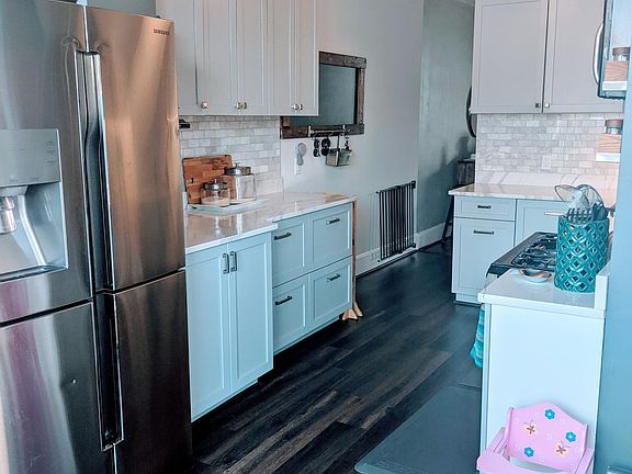 Counter-depth Samsung fridge, Bosch dishwasher, 48" high cabinets, quartz countertops