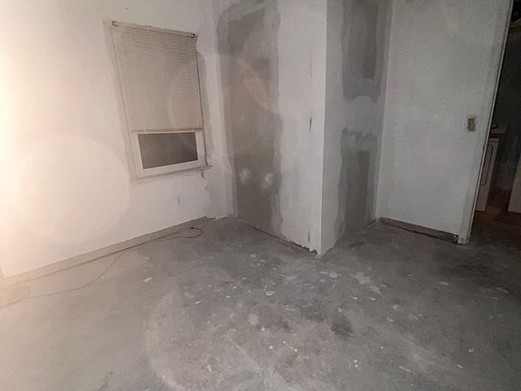 This bottom-floor bedroom features hardwood floors a ceiling fan for a cool atmosphere and a spacious closet for ample storage. A full bathroom is conveniently located just steps away.