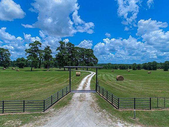 Welcome to 492 Bowden Rd in the heart of Huntsville!  Black steel pipe gate and riding gate entry lead you down 1.1 miles of frontage volcanic ash road through gently rolling green pastures, mature trees and beautiful wide open blue skies.