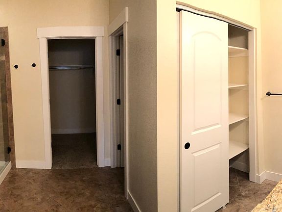 Master bath with walk in closet, private toilet and jetted tub