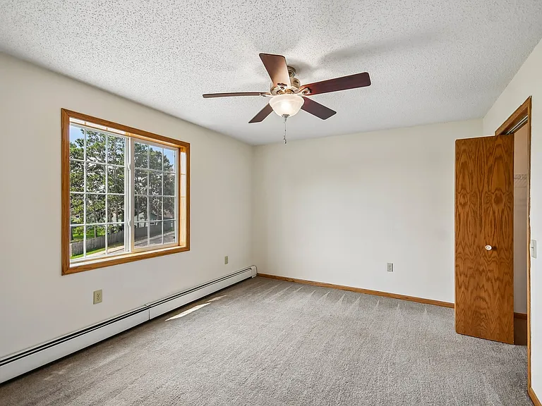 Step into your future at Mill Pond Apartments! This spacious bedroom features ample natural light, a charming ceiling fan, and a cozy ambiance. It's the ideal canvas for your personal style. Schedule a visit today to see your new home!