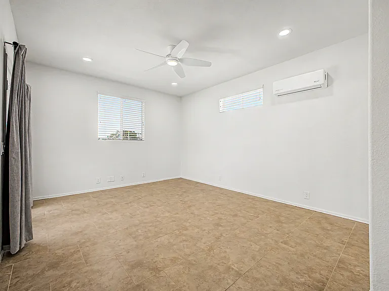 Main floor Bedroom 1 with mini-split & French Doors