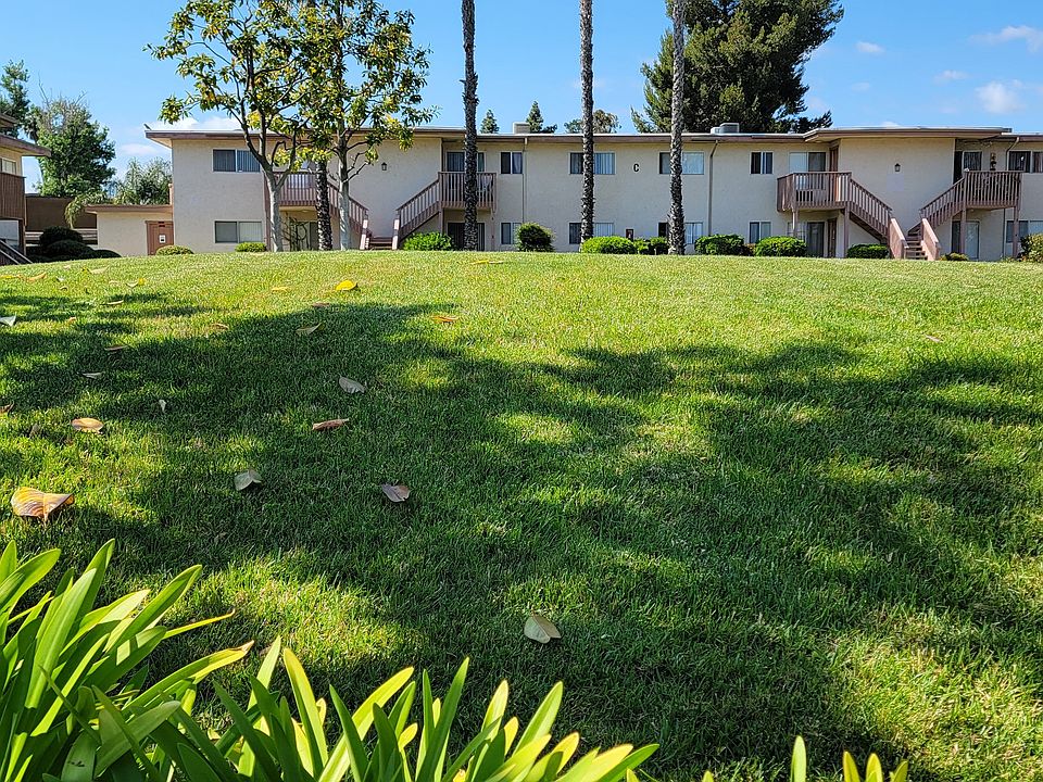 Large grassy areas with well cared for landscaping around buildings at Plaza Verde Apartments in Escondido, California.