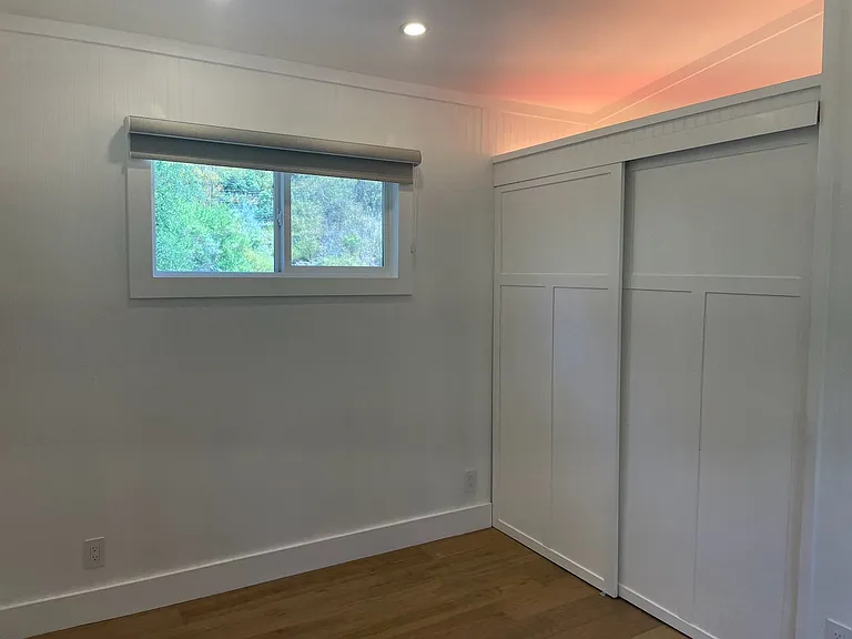 Bedroom fits a queen size bed with 2 small night stands. Extra storage in loft above closet.