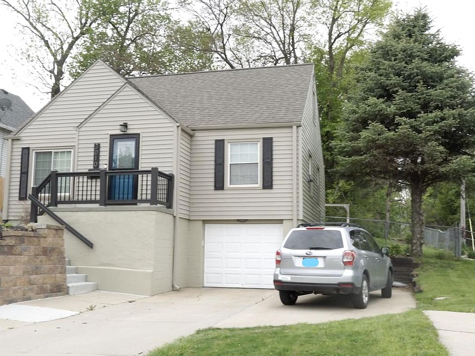 Garage with additional parking on side.