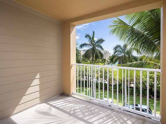 Covered Lanai with lovely view of the marina and palm trees is accessible from both the living room and the Second Bedroom.