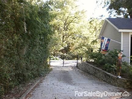 Drive : View down drive to street and remote Electric estate gate