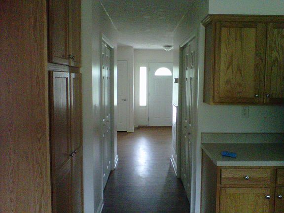 View of entry and utility/appliance closets from kitchen by pantry