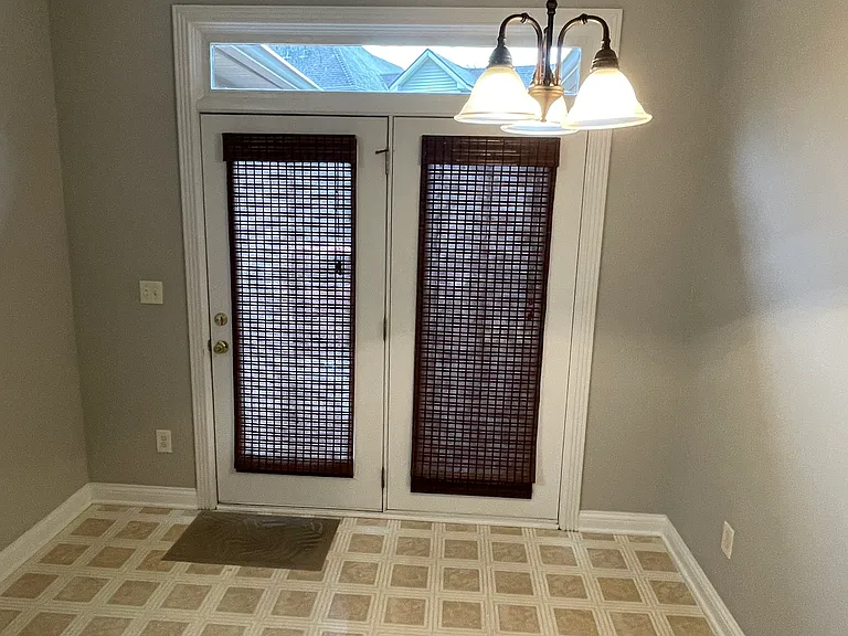 Eat- in kitchen with transom window and patio door