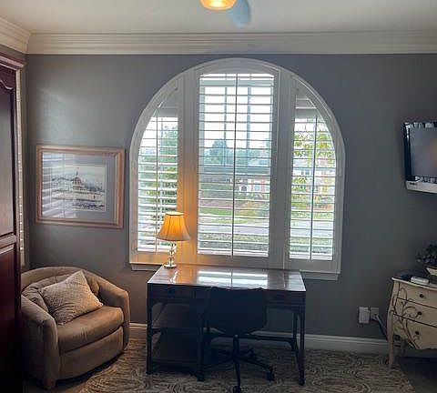 Lots of natural light, spacious desk area. Fan has automatic remote.