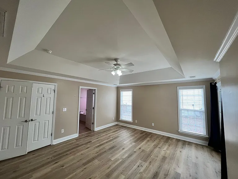 Master BR with a master bathroom and walk-in closet