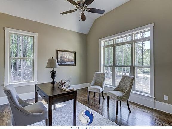 The raised roof office directly to the right of open front door is large and has a beautiful view out to front.