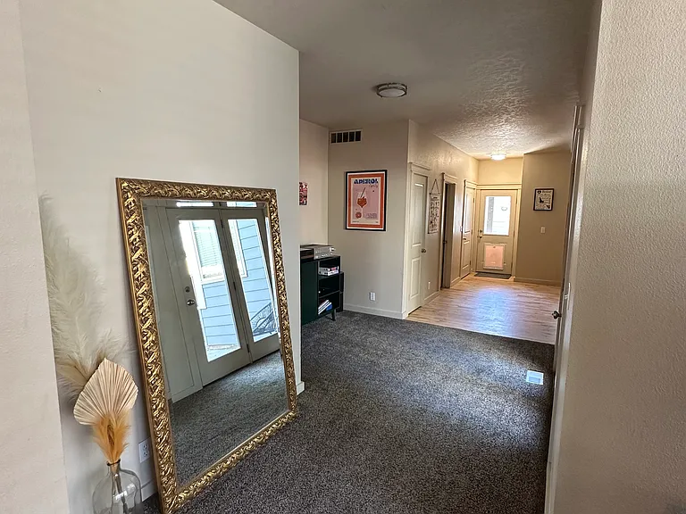 down stairs living room with massive full length mirror