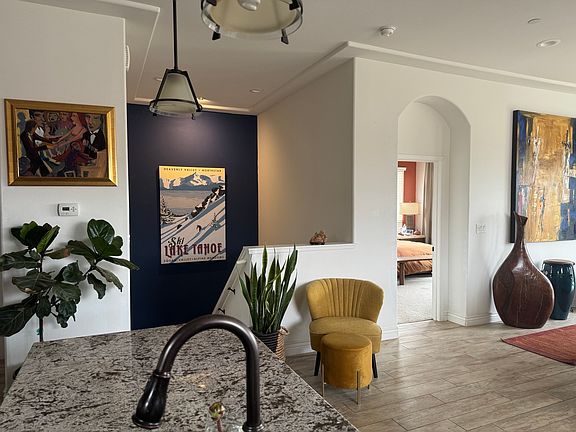 Side view from kitchen island towards master bedroom. Master bedroom opens to main floor living room and kitchen