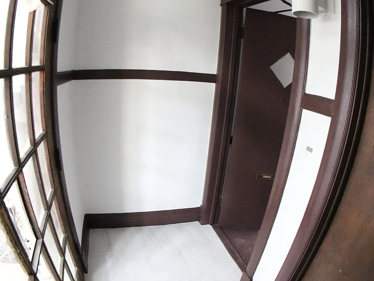Entrance hallway with ceramic tile flooring.