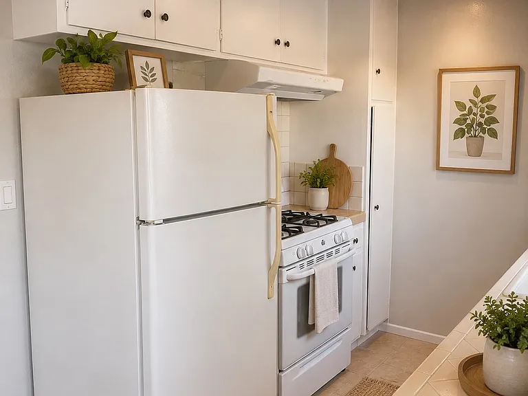 Kitchen with original wood cabinetry, refrigerator and stove