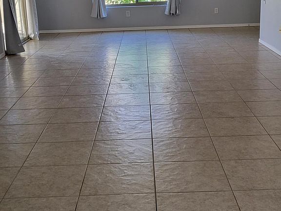 Living Area. To the right of the window is the front door and to the left.a sliding glass door to the backyard.