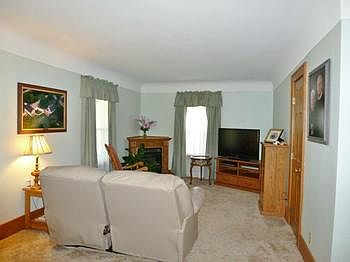 Spacious living room with 2 conversation areas.  This one has a gas-log fireplace in the corner.  Originally, this part of the living room was a bedroom.  The closet still remains!