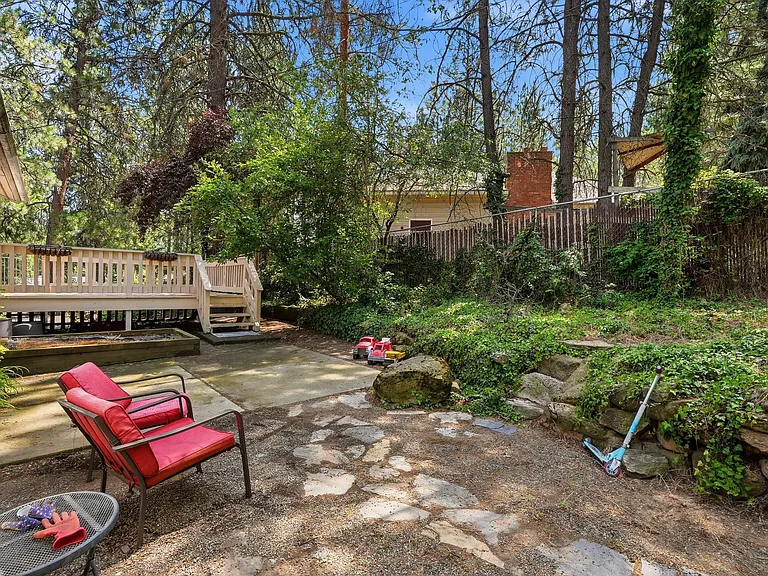 cute back area beside deck is a peaceful retreat space