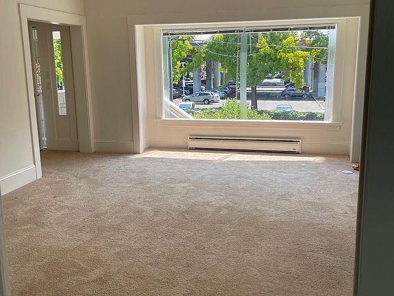 Living room with huge window + lots of natural light
