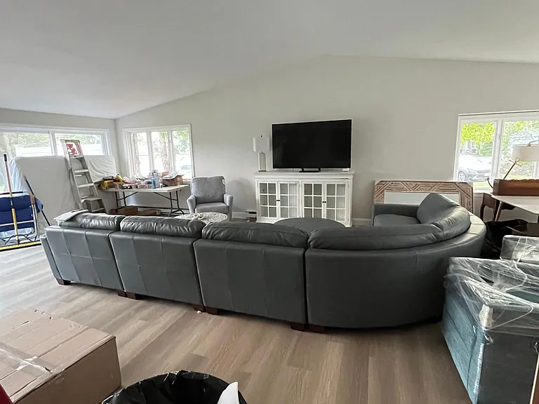 Living room with open concept and vaulted ceilings from front to back.