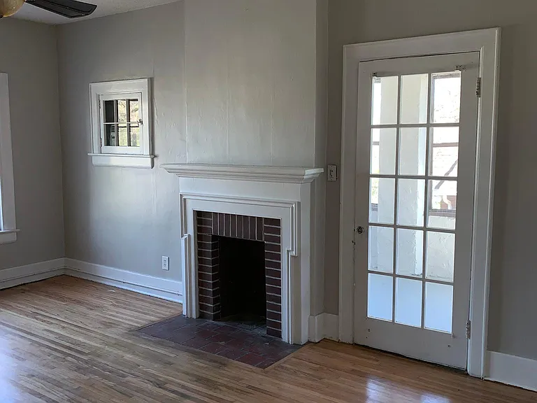 Large living room with access to front porch (fireplace adds atmosphere but is not functional)