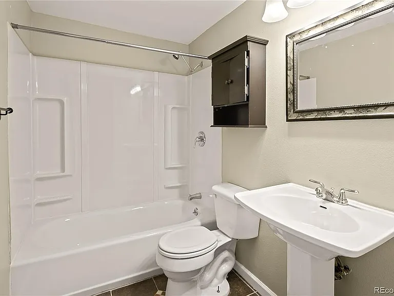 Downstairs full bathroom (upgraded sink fixtures and shower hardware not pictured).