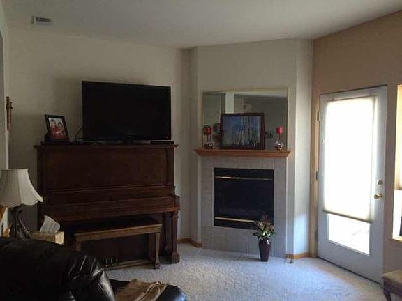 Living room with gas fireplace and balcony access