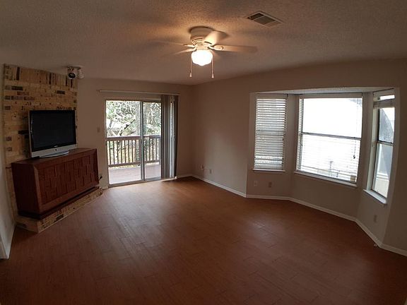 Spacious living room with a great view and built-in TV stand and entertainment center.