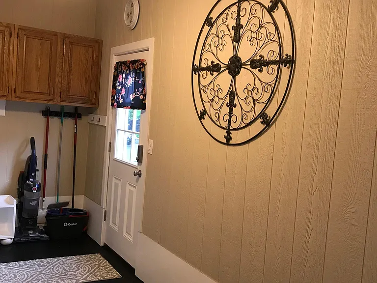 Large mudroom with cleaning supplies
