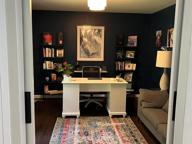 Formal office space that can flex as a separate living room or library, with barn doors for privacy.