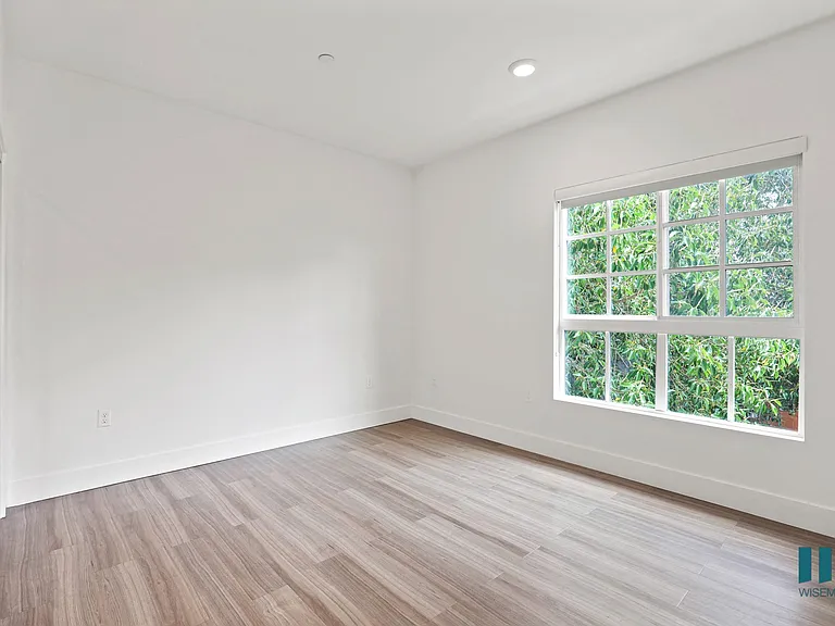 Bedroom with Large-Size Windows, Vinyl Flooring, Recessed Lighting, and Mirrored Closet