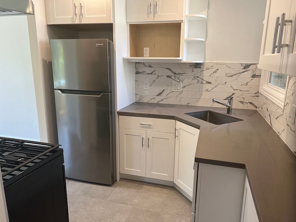 Newly remodeled kitchen with new refrigerator, stove and tiled floor