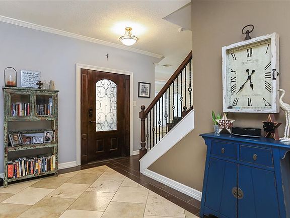 Stairway has been updated with wrought iron spindles. This view shows the inside of the beautiful front door.