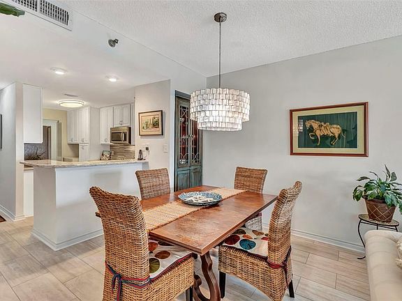 Dining room is spacious. Note the corner cabinet is conveyed with the condo and the plumbing is still there for a wet bar if the new happy owners wish to switch it back.