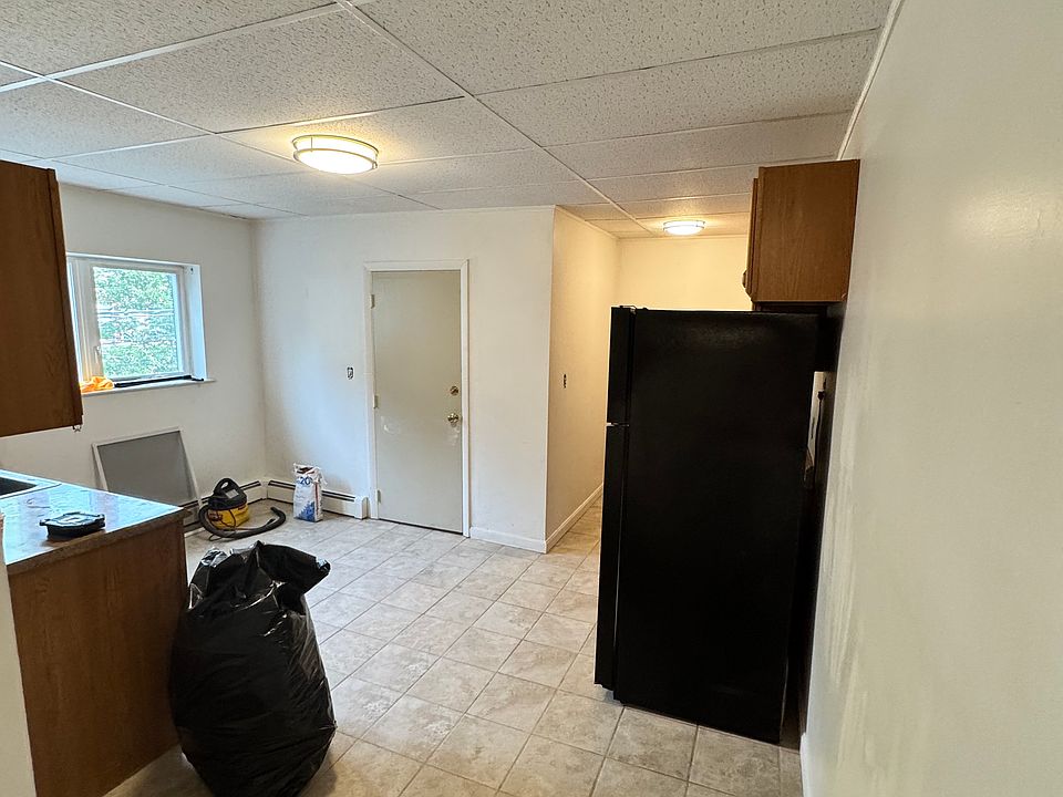 Nice-sized kitchen with lots of light. The stove and fridge are on one side of the kitchen, and the sink is on the other side.