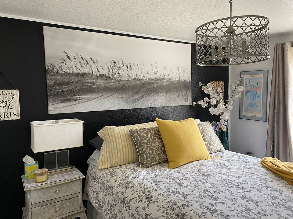 Comfortable Queen-size bed with dresser and end tables.