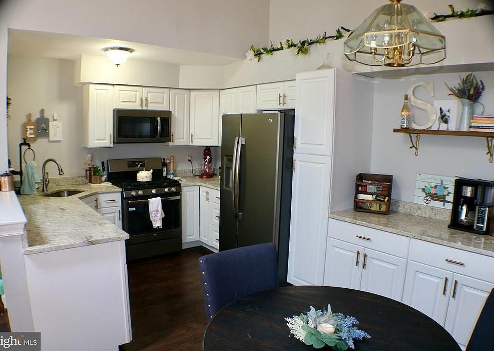Kitchen with black stainless steel appliances and granite countertops