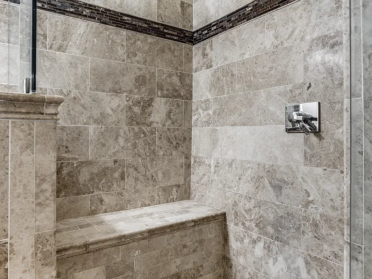 Start or end your day in this spa-inspired marble shower with raincan shower head..