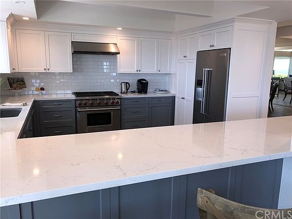 New Kitchen with Stainless Steel Appliances and opens to Fam