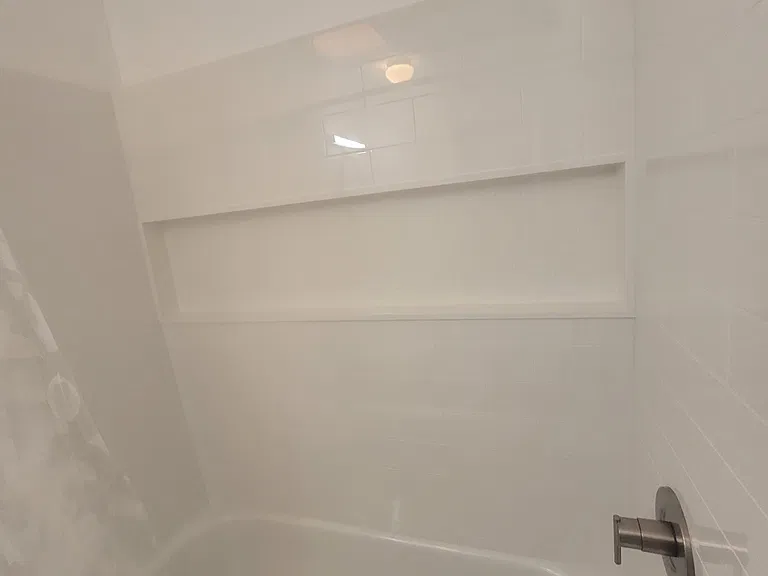 Brand new tub and tub surround with large niche.