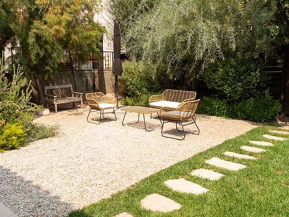 Enclosed private yard with mature landscaping perfect for morning coffee or evening unwinding. Weekly gardening service included.