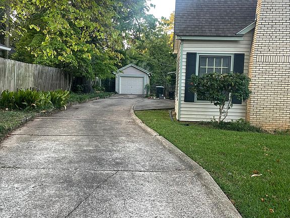Camilla bush and two dogwoods on left of driveway